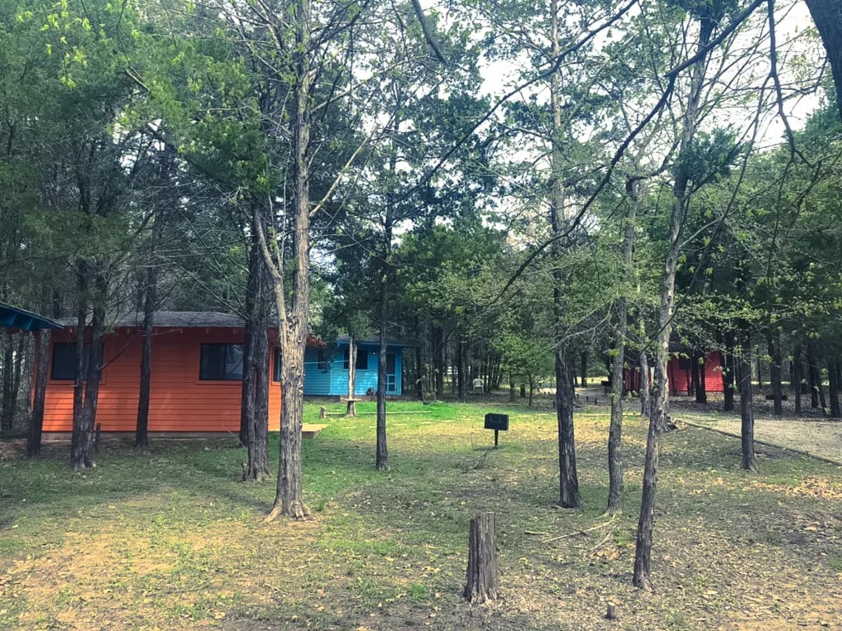 Colorful tiny cabins tucked among the trees at Sundance Camp